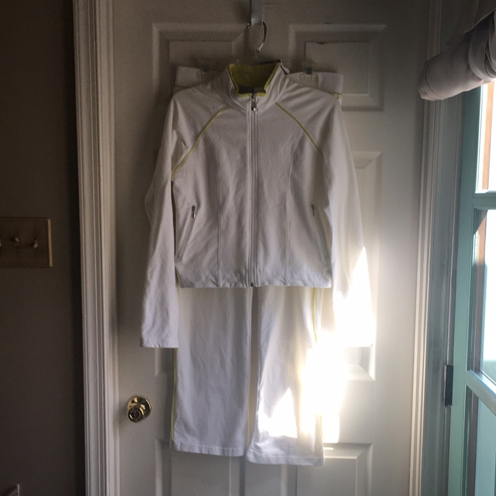 White knit fabric with lime colored piping. Zip jacket jogging suit and pants.